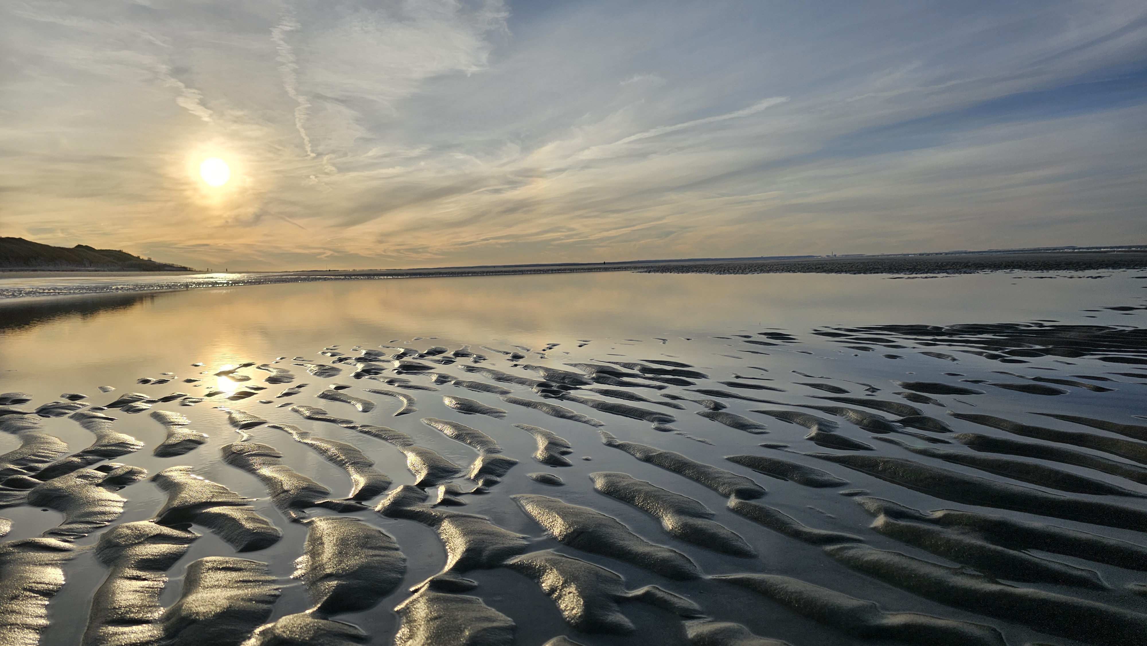 An image of the sun rising over a Cape Cod beach.