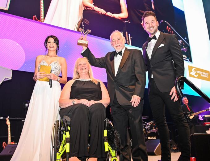 David Gemmell smiling and holding an award.