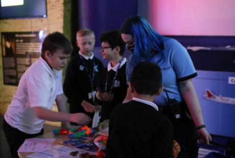 Guide interacting with students around a table