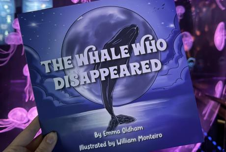 The Whale Who Disappeared book in front of the Moon jellyfish exhibit