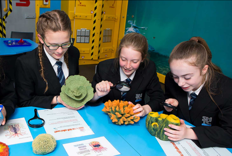 4 young students enjoying a Science with Bite session at The Deep